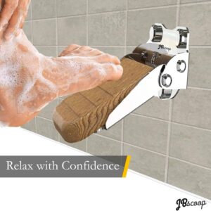 Foldable stainless steel shower footrest on tiled wall
