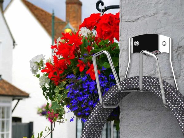 Outdoor hose storage mounted on a wall for outdoor use